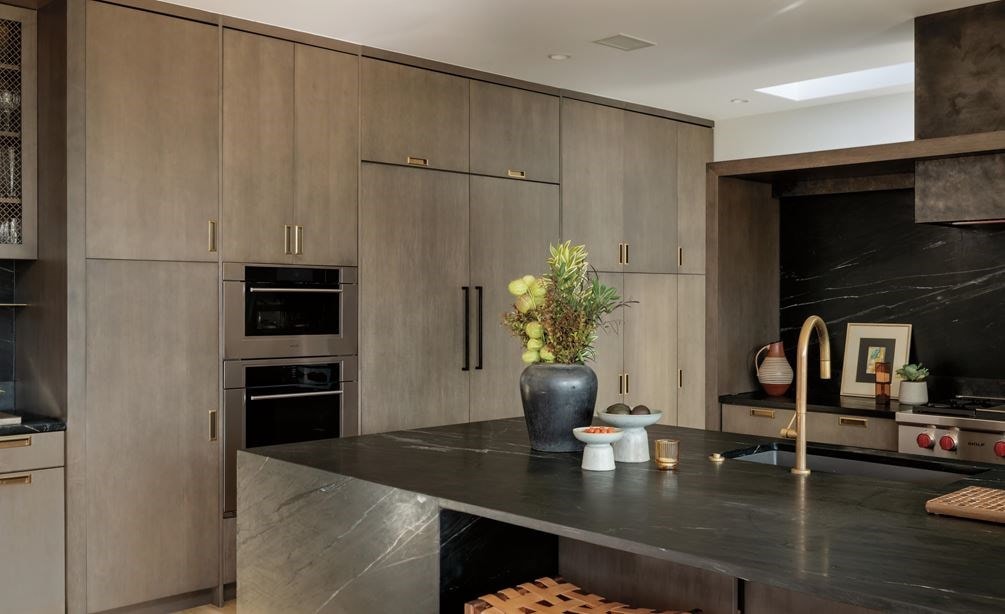 Wolf 24 Inch E Series Transitional Coffee System featured in a luxury coffee bar area with leather swing back chairs