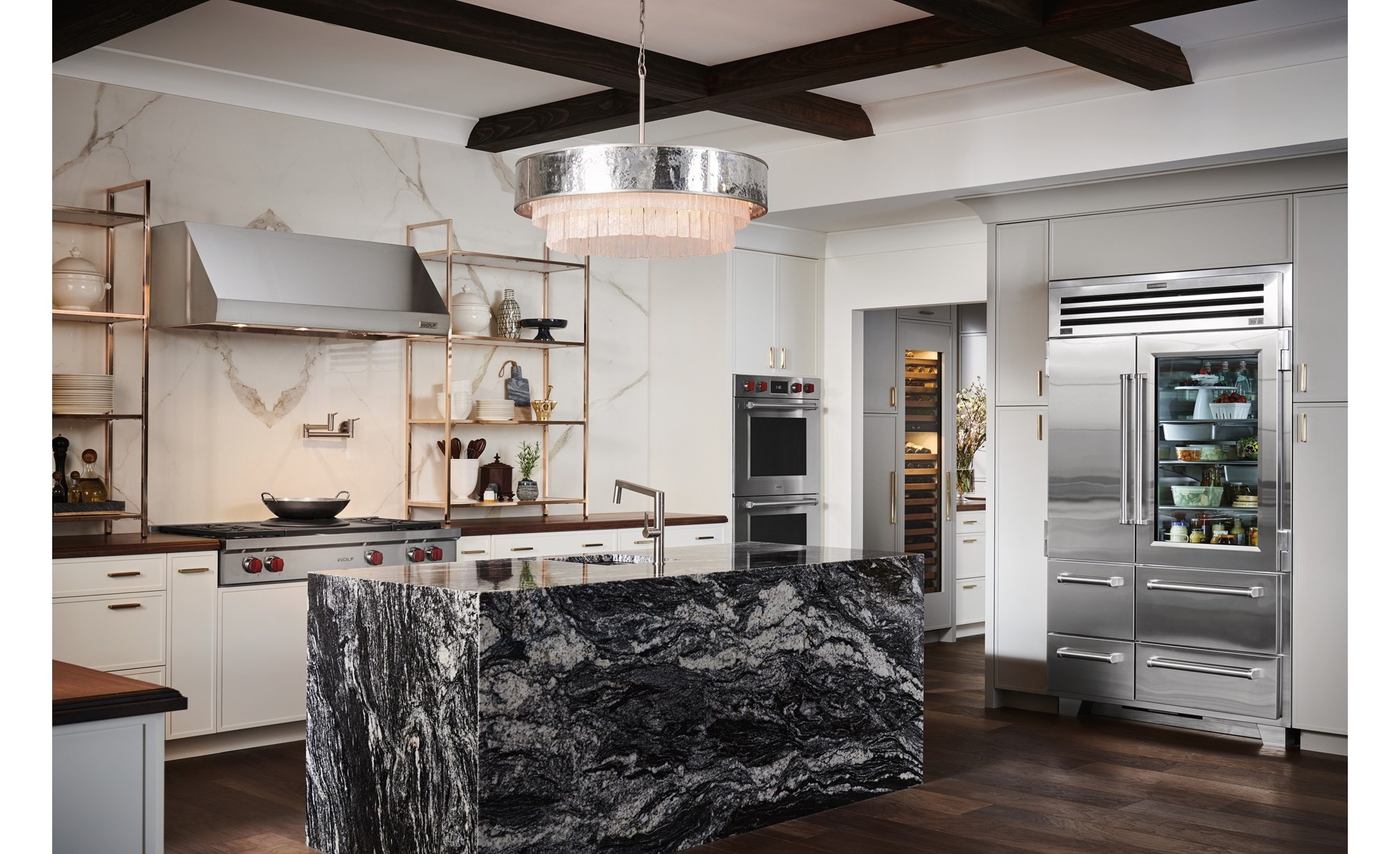 Sub-Zero 48 inch Pro Glass Door Refrigerator Freezer displayed in a large luxury rutic kitchen design featuring warm wood tone countertops and flooring