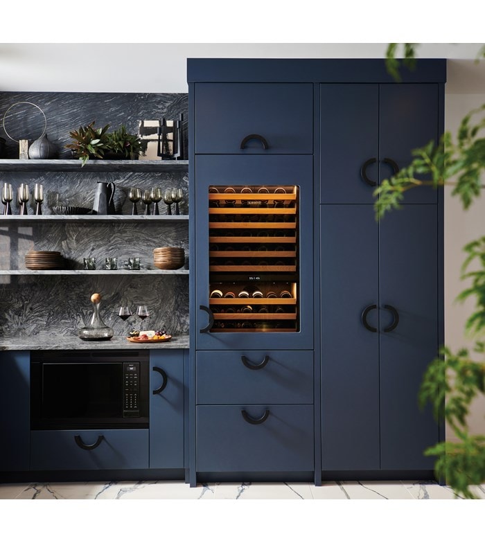 Sub-Zero 30 Inch Wine Column for High Altitude shown set flush within a custom midnight blue butler's pantry outfitted with rod iron handles