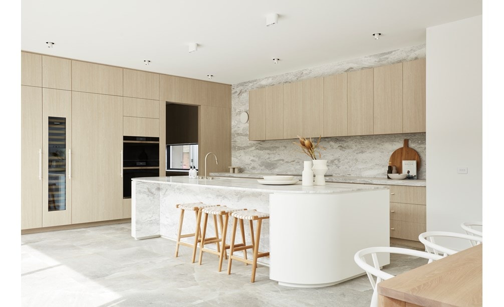A stylish white kitchen featuring Sub-Zero and Wolf products
