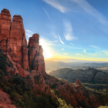 Energy vortexes can be found throughout the world, like this energetic sunrise behind a cascading rock formation.