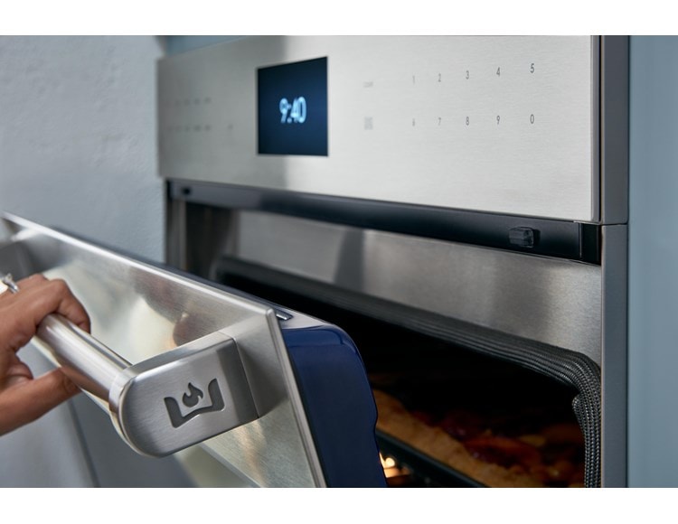 Chef product demonstration with Wolf Dual Stacked Burners at Sub-Zero, Wolf and Cove Showroom in Parma, Ohio