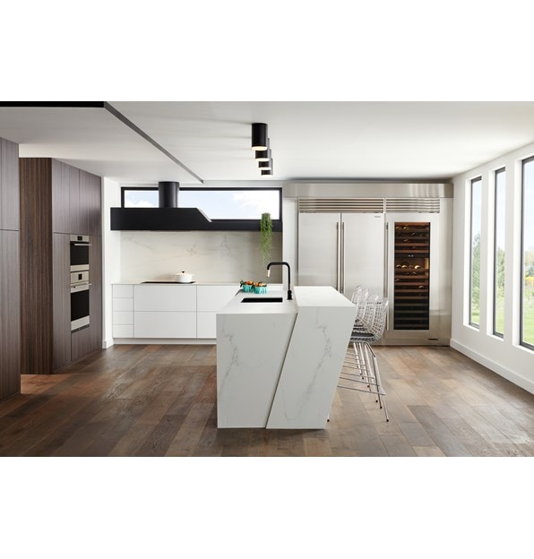 Stainless Steel Sub-Zero 48 Inch Classic French Door Refrigerator Freezer blends expertly in this sleek modern European style kitchen design featuring large white marble kitchen island.
