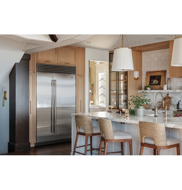Stainless Steel Sub-Zero 48 Inch Classic Side-by-Side Refrigerator Freezer featured in a light and open custom kitchen design featuring soft wood tones