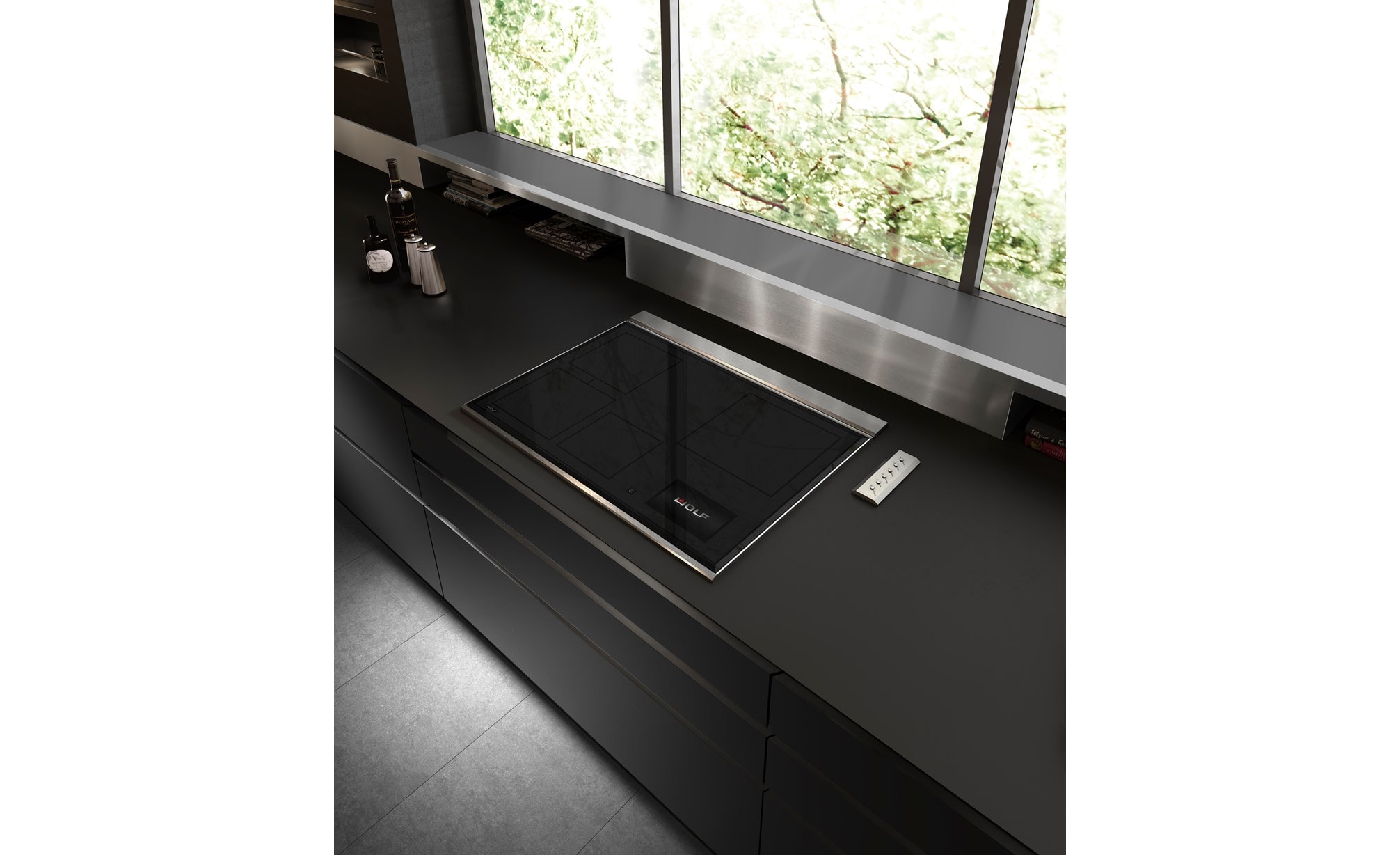 Wolf 30" Transitional Induction Cooktop (CI30460T/S) displayed in a sleek ultra modern kitchen design featuring smooth black countertops, stainless steel backsplash and handleless cabinets 
