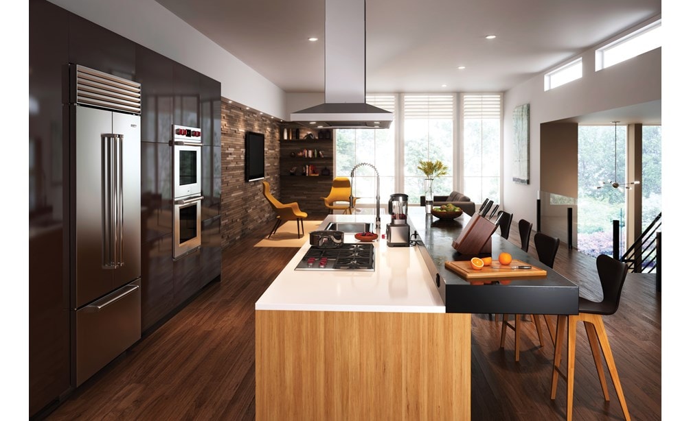 The Wolf 36" Professional Gas Cooktop (CG365P/S) displayed in large center island surrounded by an array of rich earthy tones and textures