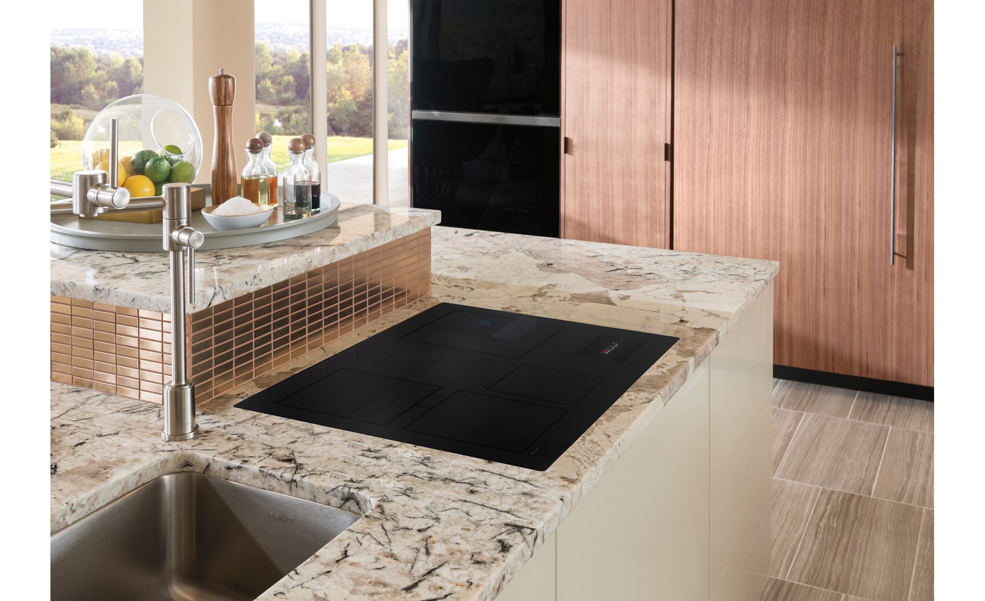 Wolf 30" Contemporary Induction Cooktop shown flush mounted in gray and white marble kitchen countertop.