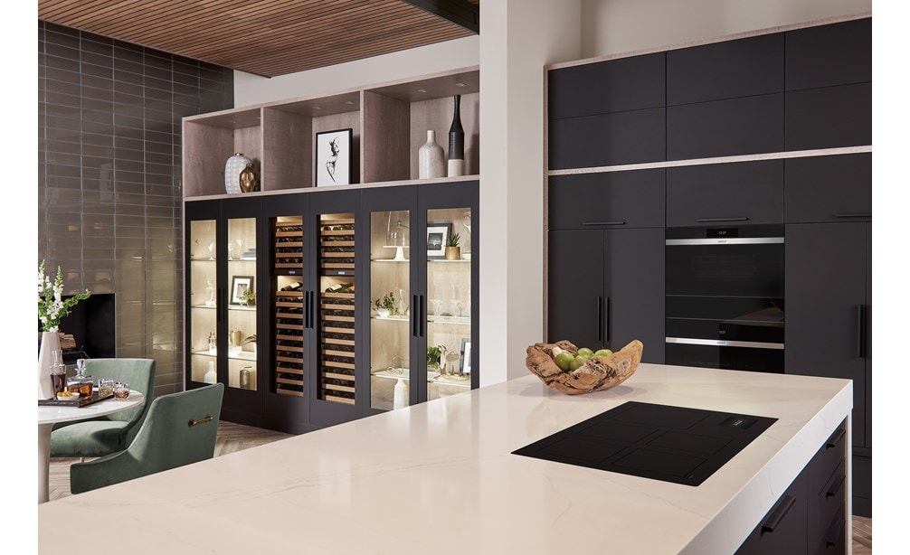 Wolf 36 Contemporary Induction Cooktop (CI36560C/B) featured in an open kitchen concept design with large white kitchen island and black kitchen cabinetry.