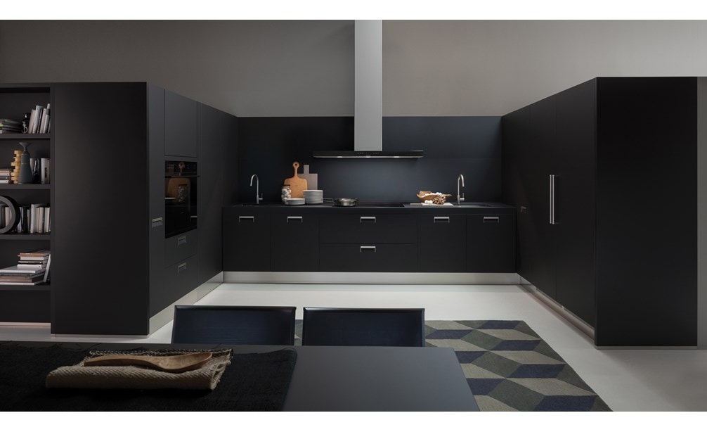 The Wolf 30" E Series Contemporary Single Oven (SO30CE/B/TH) shown blending seamlessly into a sleek dark tone contemporary room design.