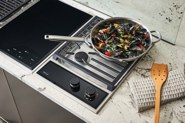 Wolf 15" transitional gas cooktop module (CG152TFS) paired with a 15" transitional electric cooktop module (CE152TFS)
