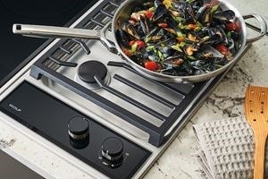 Wolf 15" transitional gas cooktop module (CG152TFS) paired with a 15" transitional electric cooktop module (CE152TFS)