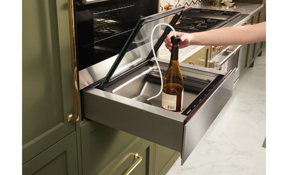 The Wolf 24" Vacuum Seal Drawer (VS24) shown protecting and prolonging the life of uncorked wine using the attachment provided 