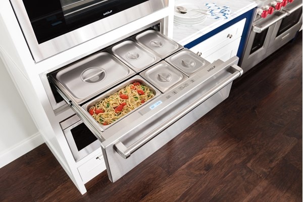 Wolf 30" Warming Drawer (WWD30) open holding an entrée and several sides containers 