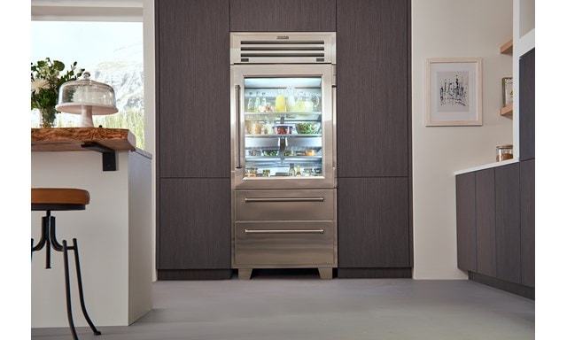 Sub-Zero Pro Glass Door Refrigerator Freezer set in seamless wood grain kitchen cabinets