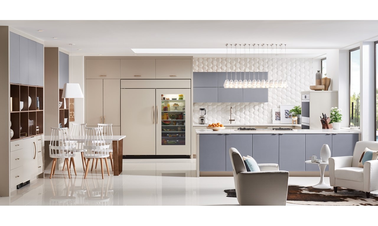 Elegant kitchen design featuring Sub-Zero Classic Series Refrigerator, Wolf Downdraft Ventilation, Wolf M Series Ovens and Module Cooktops all enclosed in custom panels