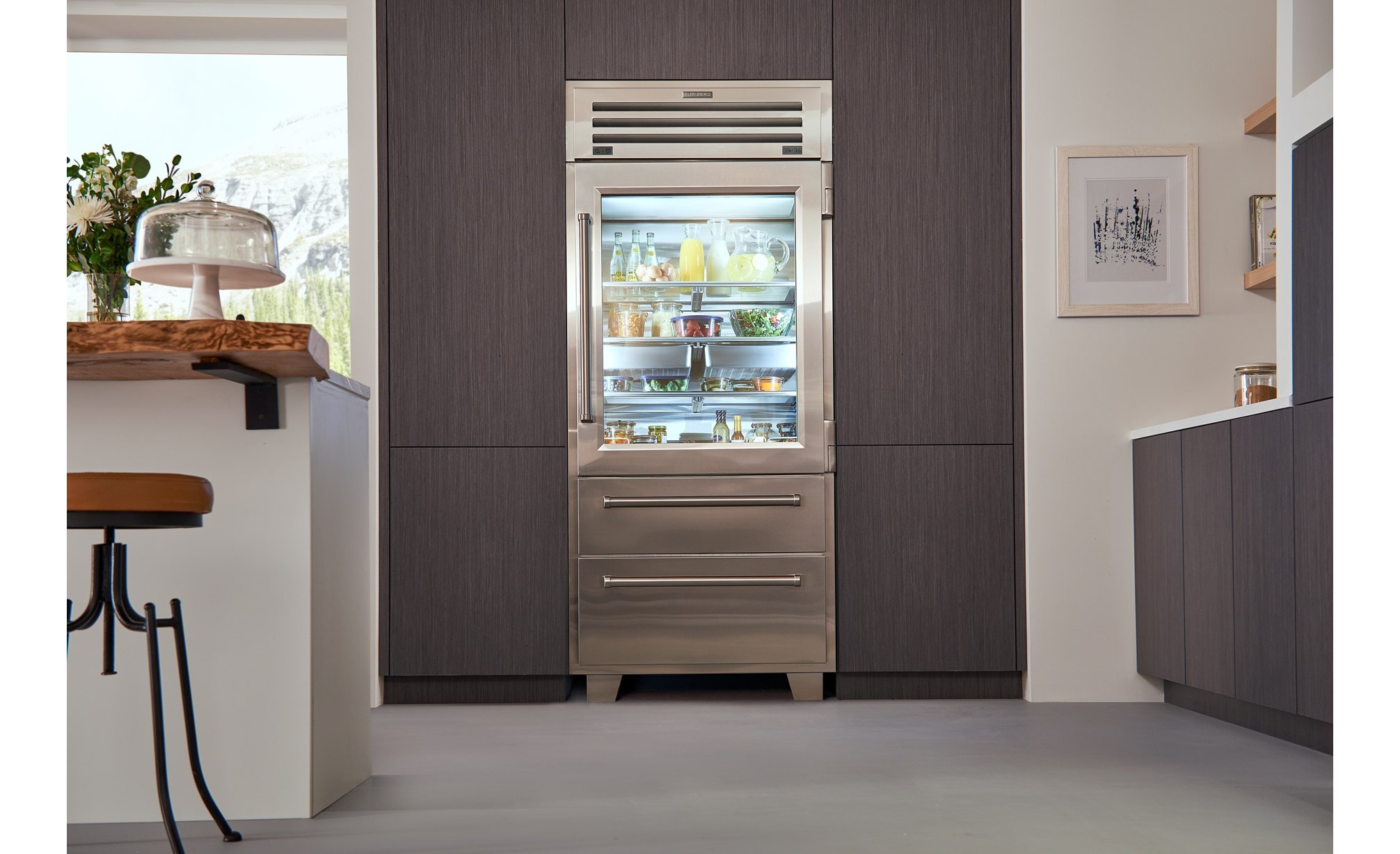 Sub-Zero Pro Glass Door Refrigerator Freezer set in seamless wood grain kitchen cabinets