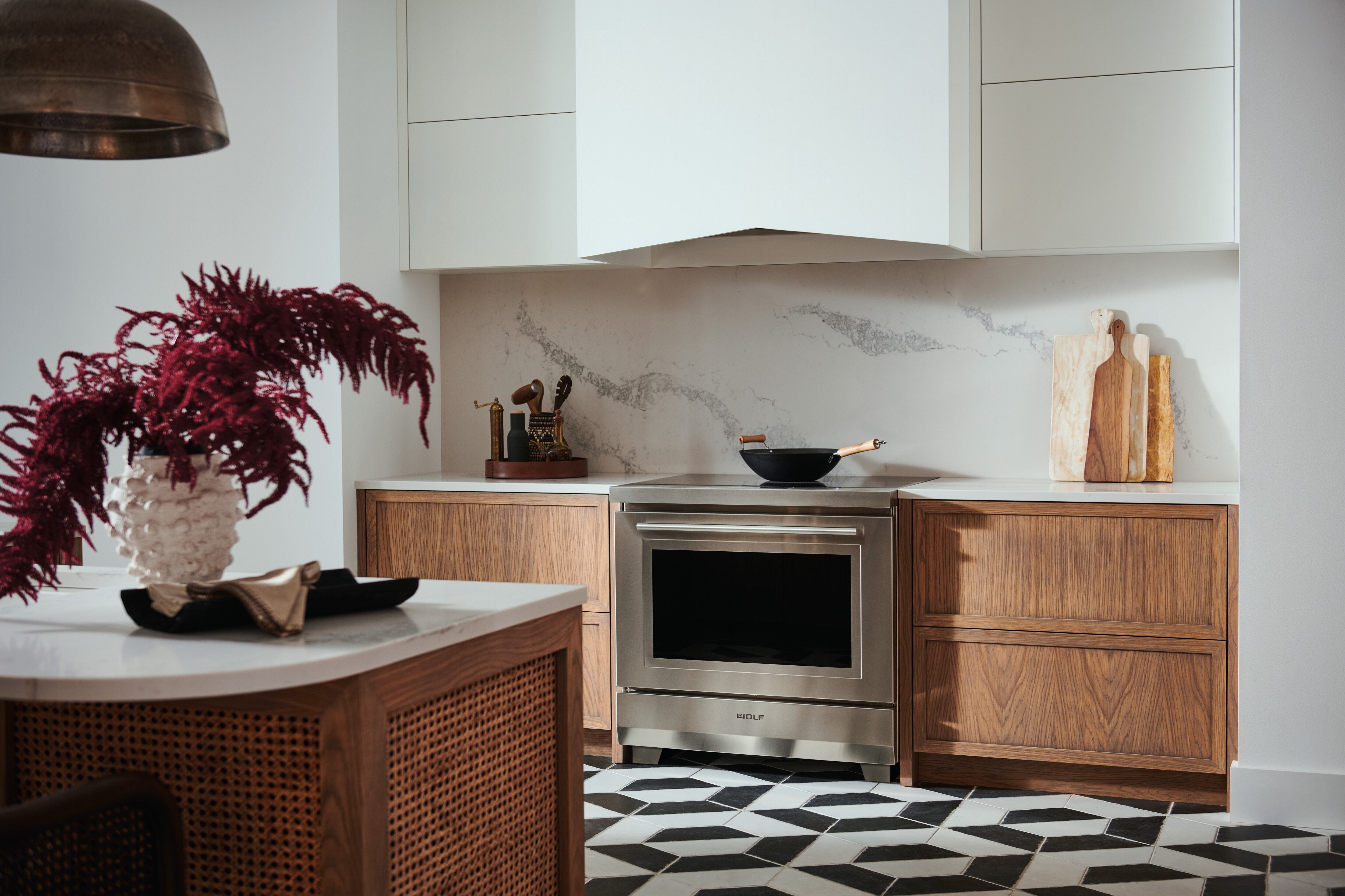 Wolf 36" Transitional Induction Range (IR36550/S/T) shown with Wolf 40" Pro Hood Liner (PL402212)