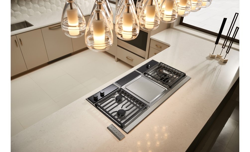 Wolf 15" Transitional Framed Gas Cooktop (CG152TF/S) shown in minimalist modern kitchen in sleek white glossy countertop island