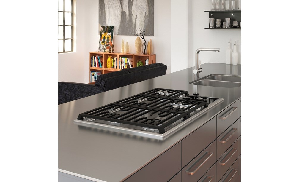 The Wolf 36" Transitional Gas Cooktop 5 Burners (CG365T/S) shown framed in clean lined stainless-steel countertop with polished accents
