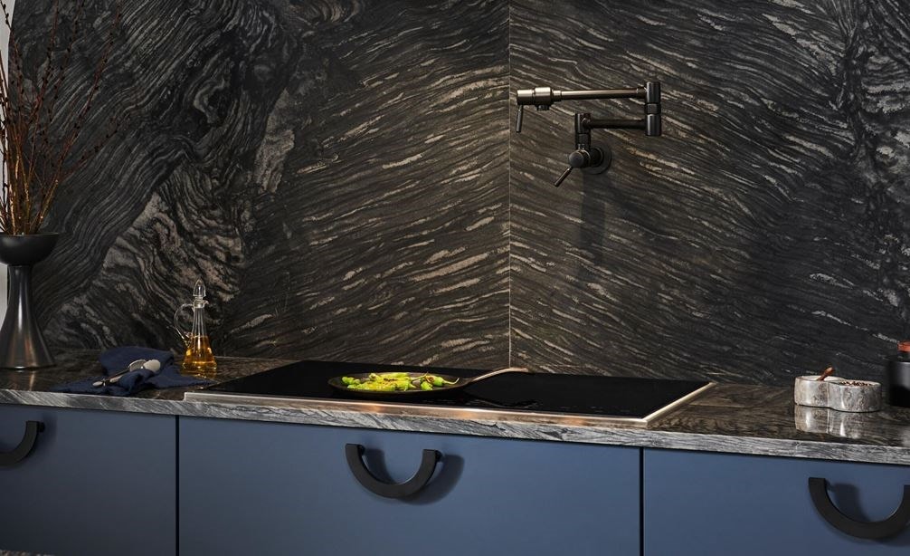 Wolf Transitional Framed Cooktop (CI365TF/S) shown in custom arched kitchen design featuring gray marble countertop and custom backsplash.