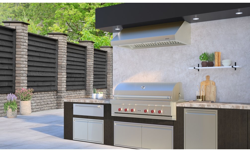 The Wolf 54" Outdoor Gas Grill (OG54) shown in a luxury outdoor kitchen featuring professional grade Wolf Outdoor Kitchen appliances.