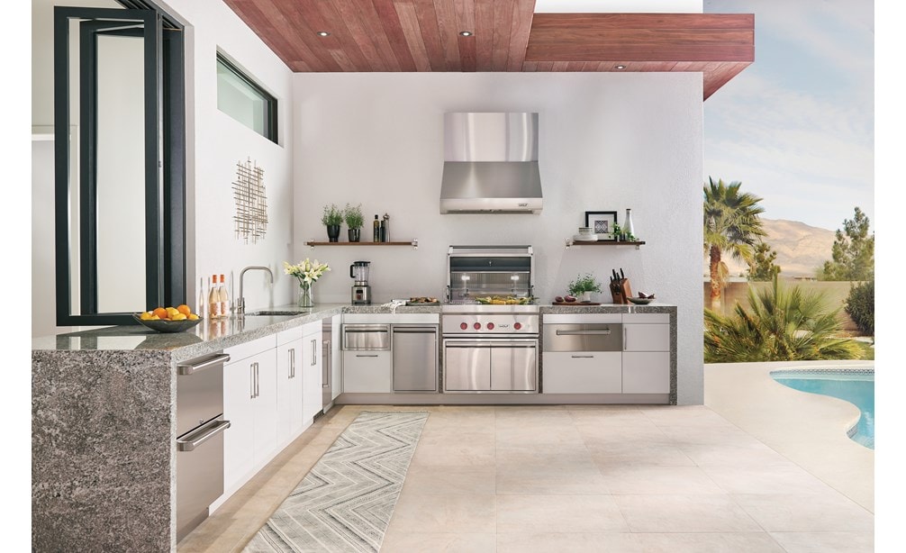 The Wolf 36" Outdoor Gas Grill (OG36) shown with Wolf 30" Outdoor Warming Drawer (WWD30O) in this luxurious poolside outdoor kitchen.