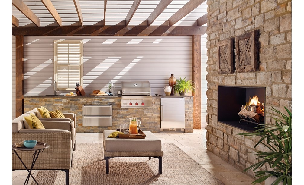 The Wolf 30" Outdoor Gas Grill (OG30) shown with Wolf 30" Outdoor Warming Drawer (WWD30O) in a luxury outdoor kitchen space.