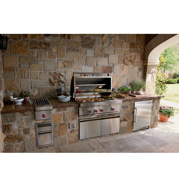 The Wolf 42" Outdoor Gas Grill (OG42) shown offering state-of-the-art kitchen amenities in a warm and rustic outdoor kitchen design.