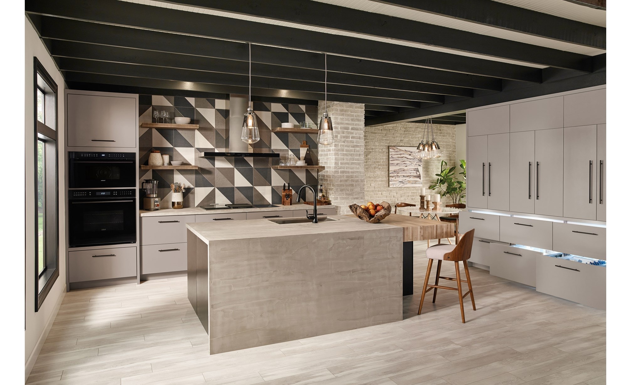 The Wolf 30" M series Contemporary Drop-Down Door Microwave Oven (MDD30CM/B/TH) shown in an open ultra-modern minimalist kitchen design