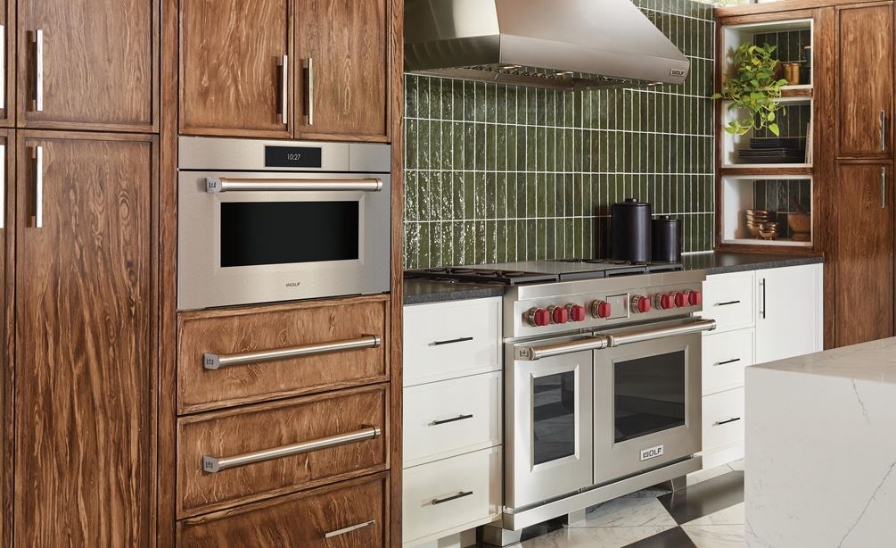 Wolf 30&quot; M Series Professional Convection Steam Oven (CSO3050PM/S/P) displayed alongside Provincial stained birch cabinets and botanical green kitchen backsplash