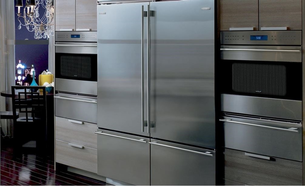 Pair of Wolf 30" E Series Transitional Classic Single Ovens (SO30TE/S/TH) on each side of Sub-Zero 30" Classic Over Under Refrigerator (BI-30U/S)