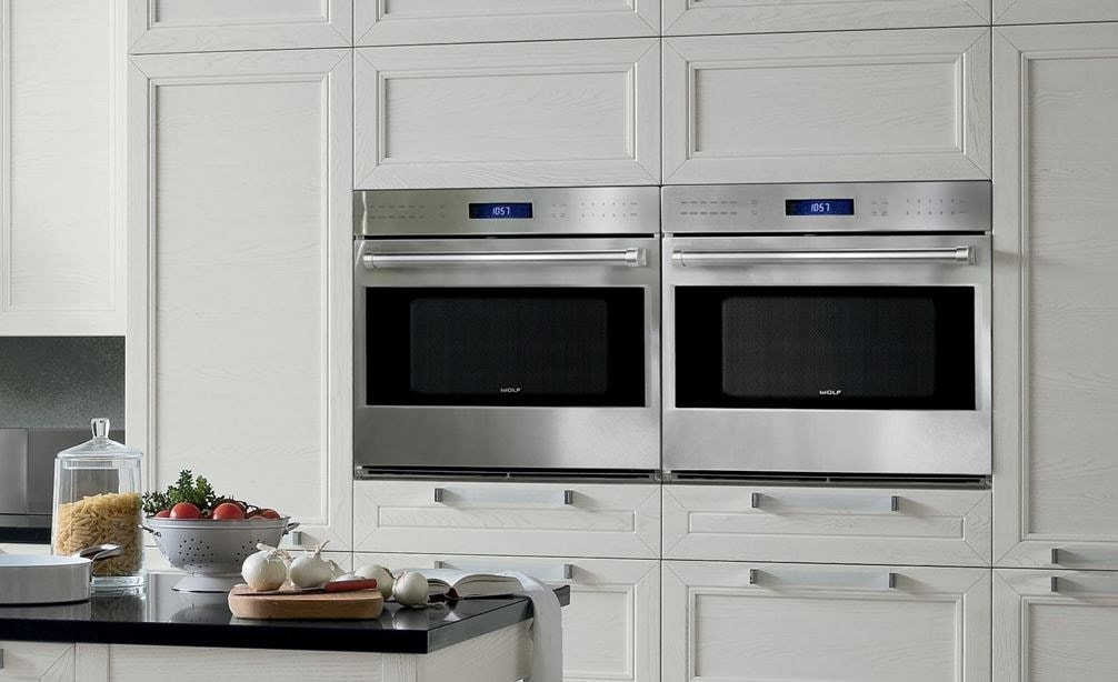 A Pair of Wolf 30" E Series Professional Classic Single Ovens (SO30PE/S/PH) displayed expertly within clean kitchen cabinetry.