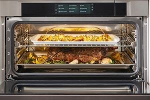 Wolf Convection Steam Oven displayed in a Mediterranean style kitchen design featuring blue tile backsplash and open kitchen shelves.