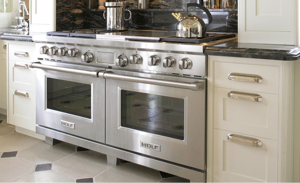 The Wolf 60&quot; Dual Fuel Range 6 Burner Infrared Charbroiler Griddle (DF606CG) shown with signature stainless steel control knobs.
